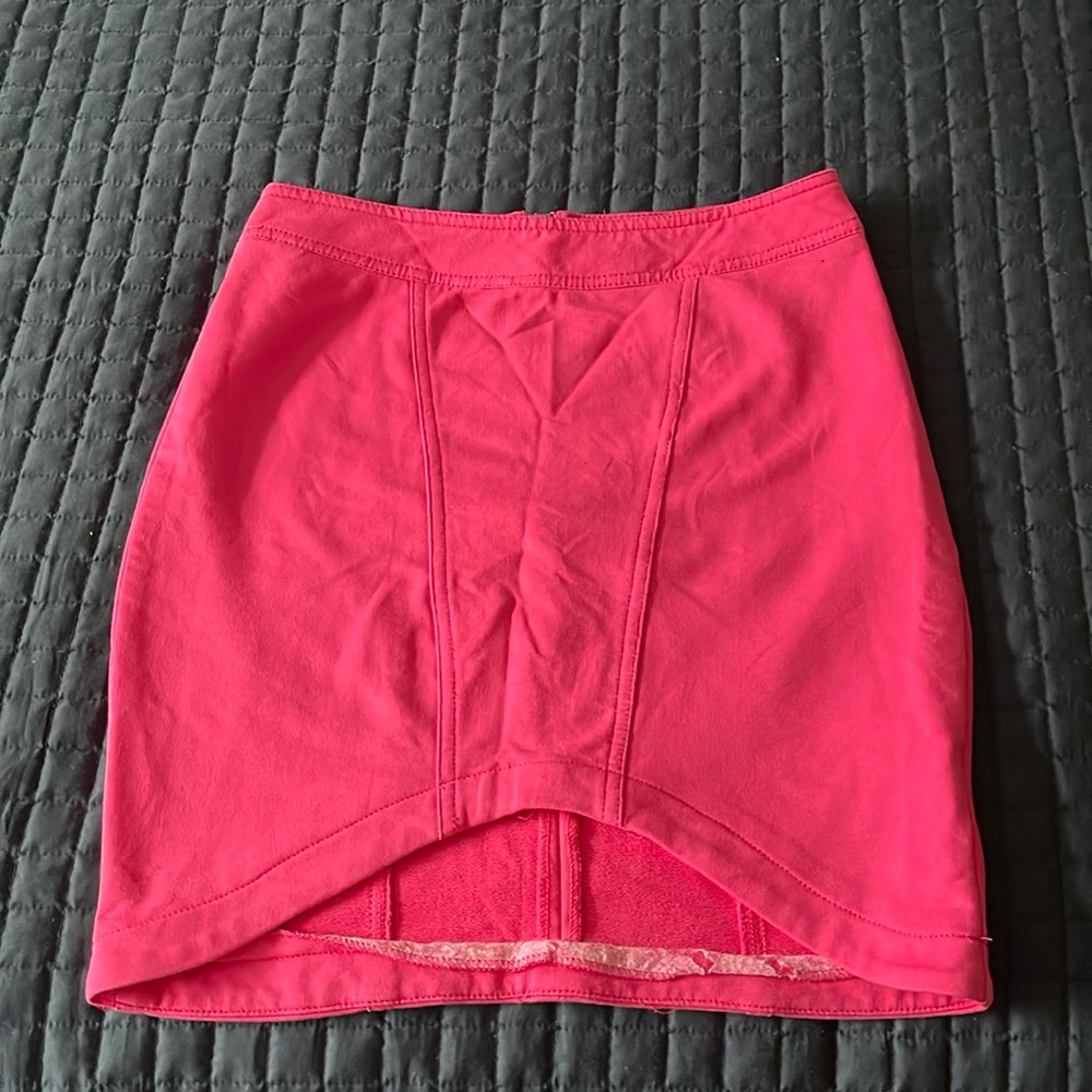 Pink skirt, shorter in the front and longer in the back. Size M